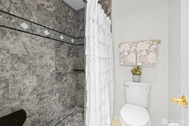 a bathroom with a toilet and shower