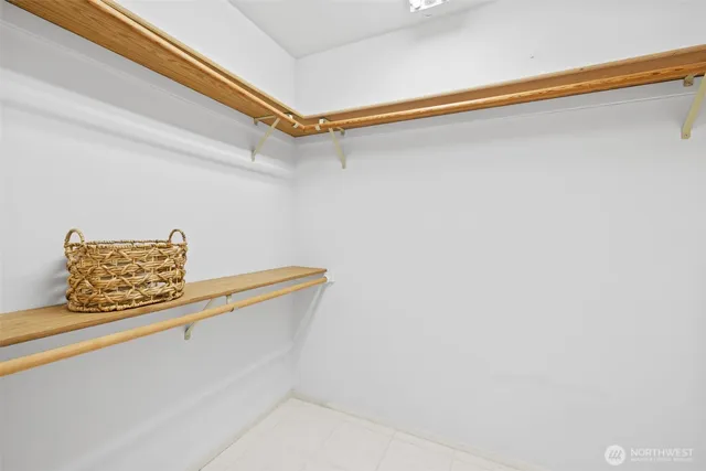 a view of roof deck with wooden floor and fence next to a yard