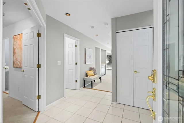 a view of a hallway with dining area and glass door