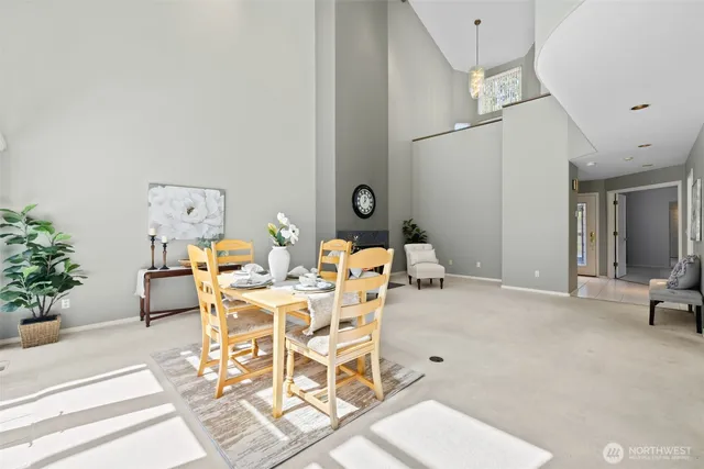 a living room with furniture a clock and a potted plant