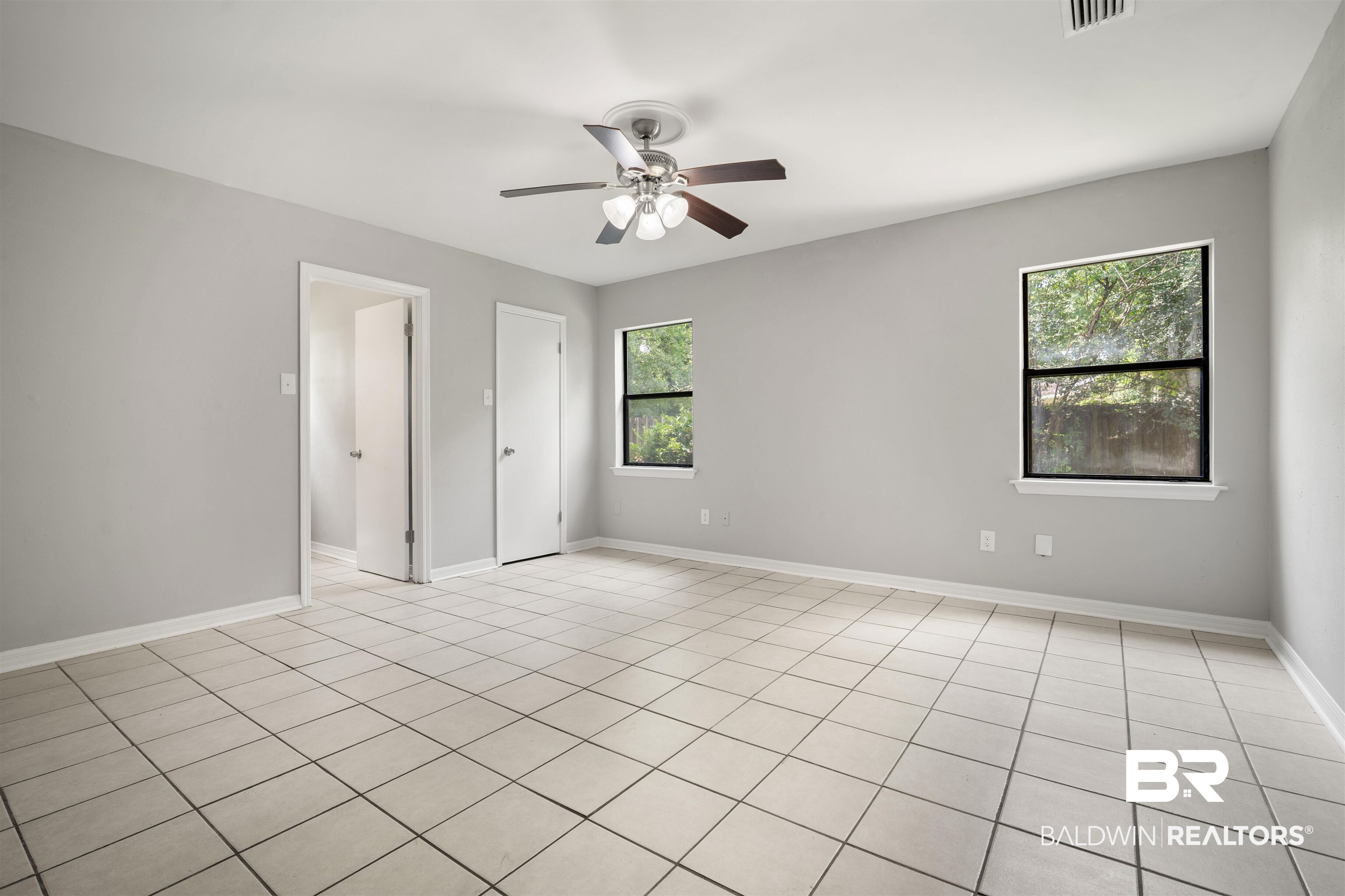 963 Shady Brook Drive Mobile, AL 36606 - Photo 13 of 20 Unfurnished bedroom with ceiling fan, light tile patterned floors, and baseboards