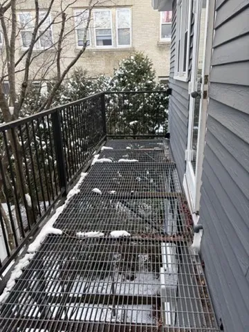 a view of a balcony with wooden floor