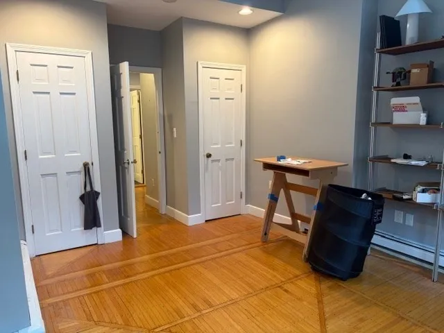 a view of a workspace with furniture and wooden floor