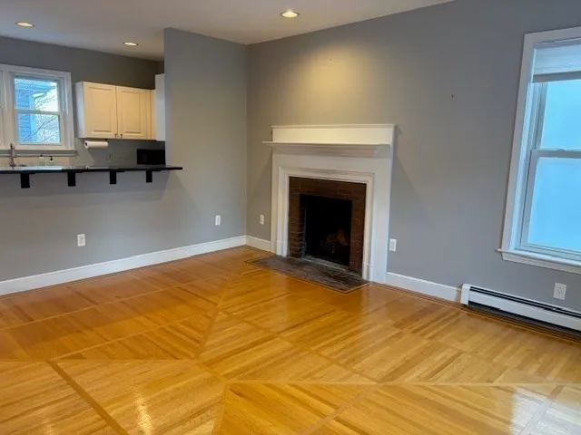 a view of empty room with window and fireplace