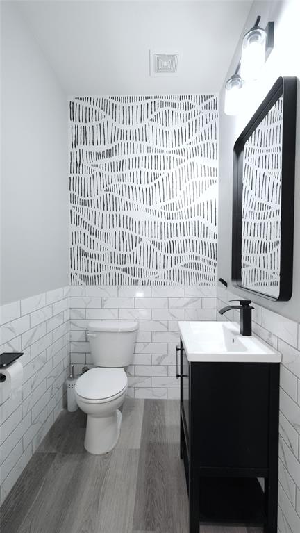 604 Allen Street, Unit 104 Austin, TX 78702 - Photo 6 of 16 a bathroom with a sink toilet a mirror and shower