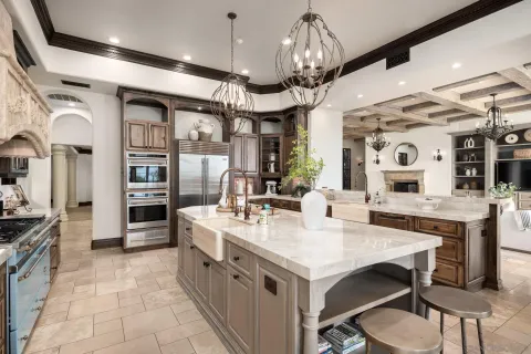 a large kitchen with a table and chairs