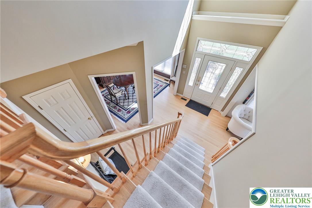 63 Long Road Lenhartsville, PA 19534 - Photo 66 of 100 An airy entry foyer showcases soaring ceilings and a wood-railed staircase leading to the main level.