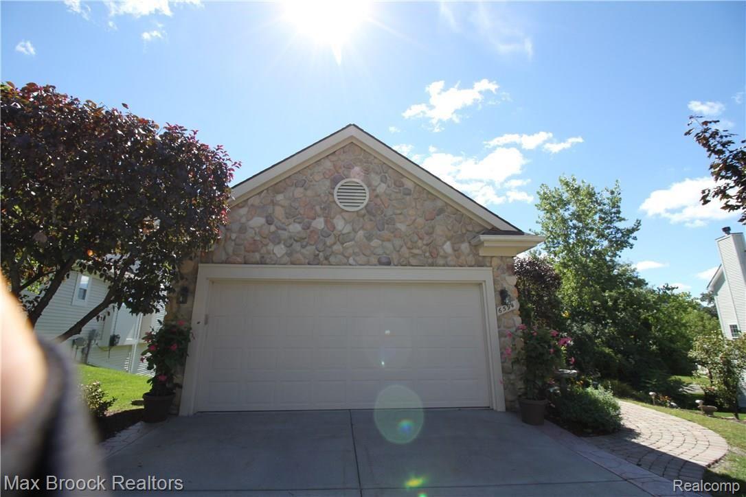 6594 Forest Ridge Court Clarkston, MI 48346 - Photo 22 of 23 Beautiful stone garage, plus extra wide concrete driveway