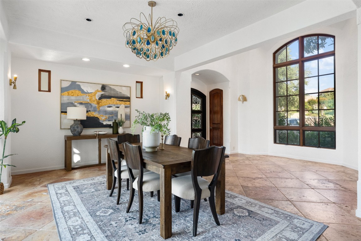 203 Bella Riva Drive Austin, TX 78734 - Photo 24 of 40 a view of a dining room with furniture and chandelier