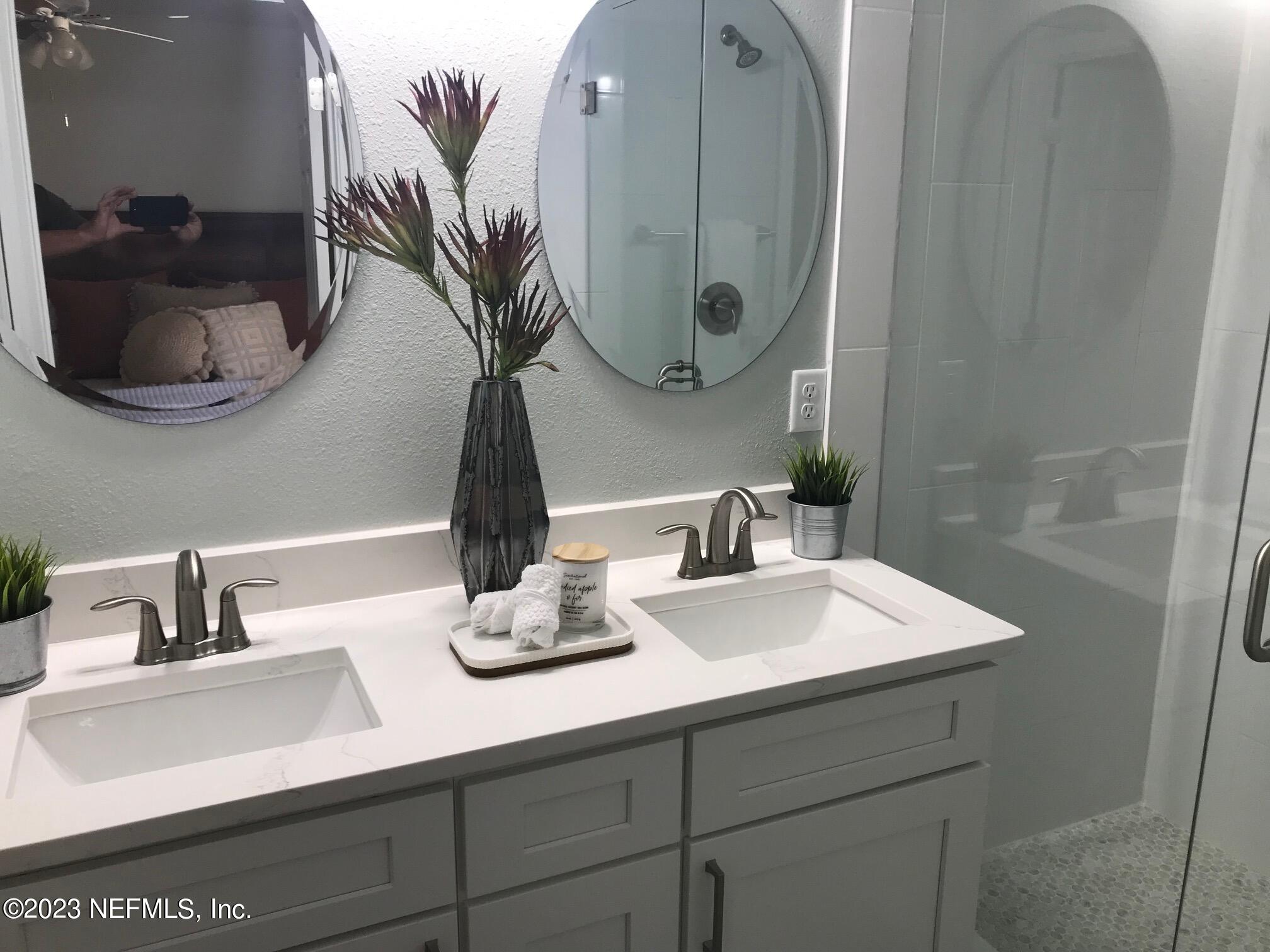 3748 Foxcroft Road Jacksonville, FL 32257 - Photo 14 of 33 a bathroom with a sink and a mirror