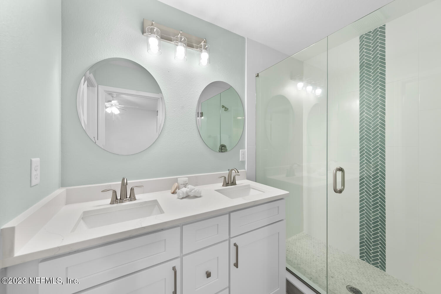 3748 Foxcroft Road Jacksonville, FL 32257 - Photo 15 of 33 a bathroom with a double vanity sink and a mirror
