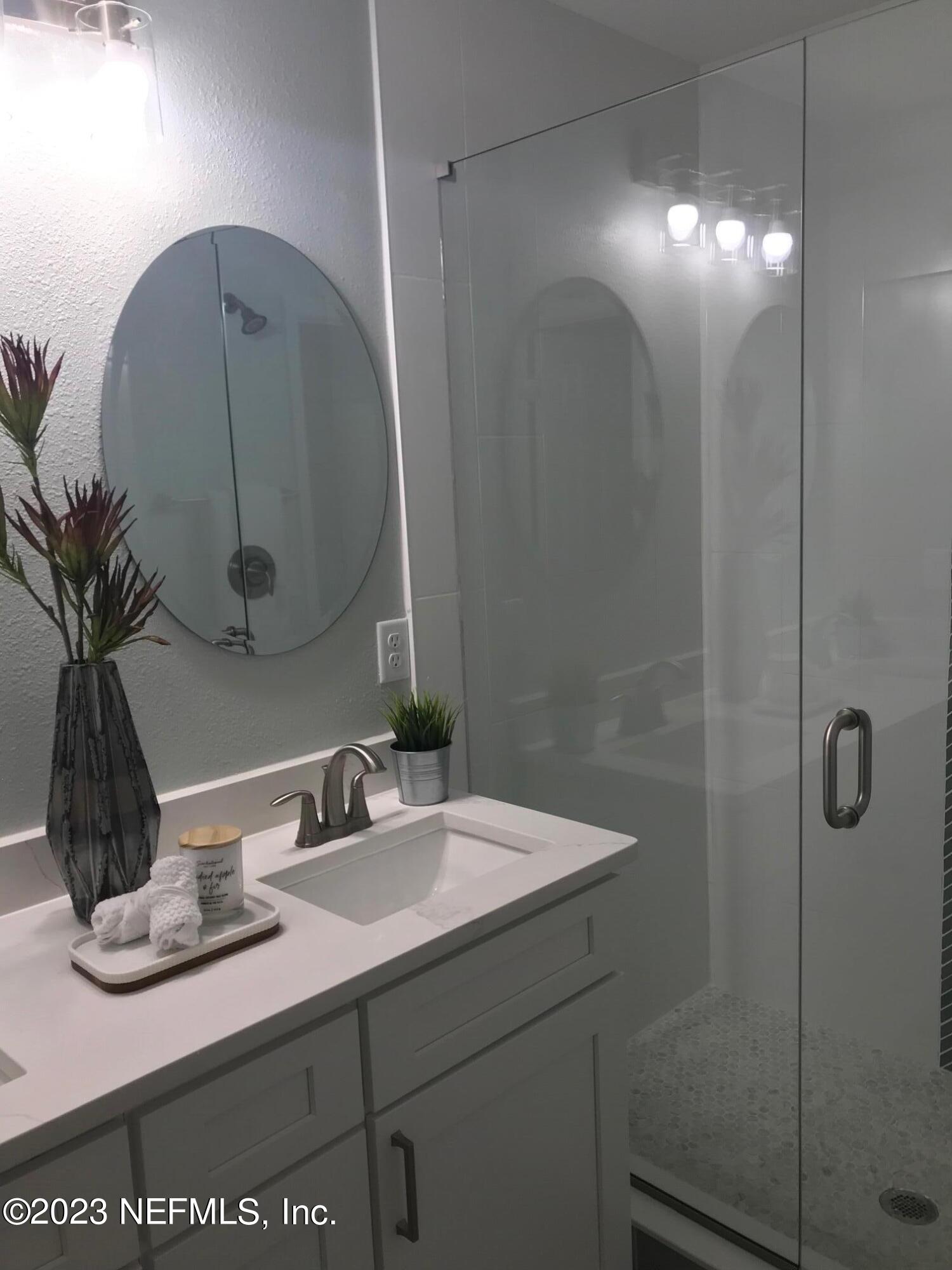 3748 Foxcroft Road Jacksonville, FL 32257 - Photo 16 of 33 a bathroom with a sink and a mirror