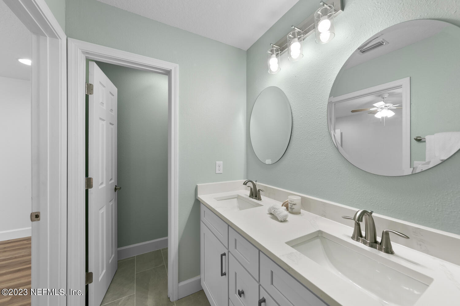 3748 Foxcroft Road Jacksonville, FL 32257 - Photo 17 of 33 a bathroom with a double vanity sink mirror and a mirror