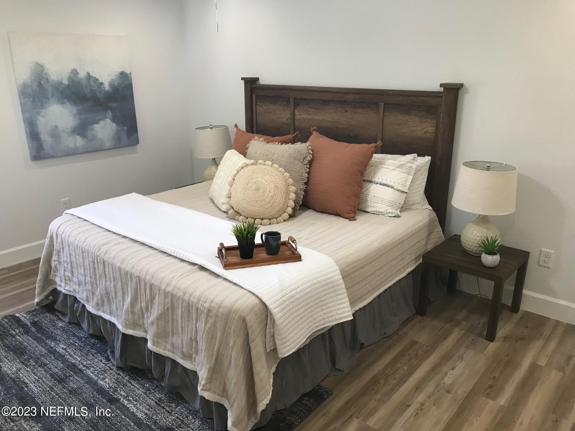 3748 Foxcroft Road Jacksonville, FL 32257 - Photo 18 of 33 a bedroom with bed and wooden floor