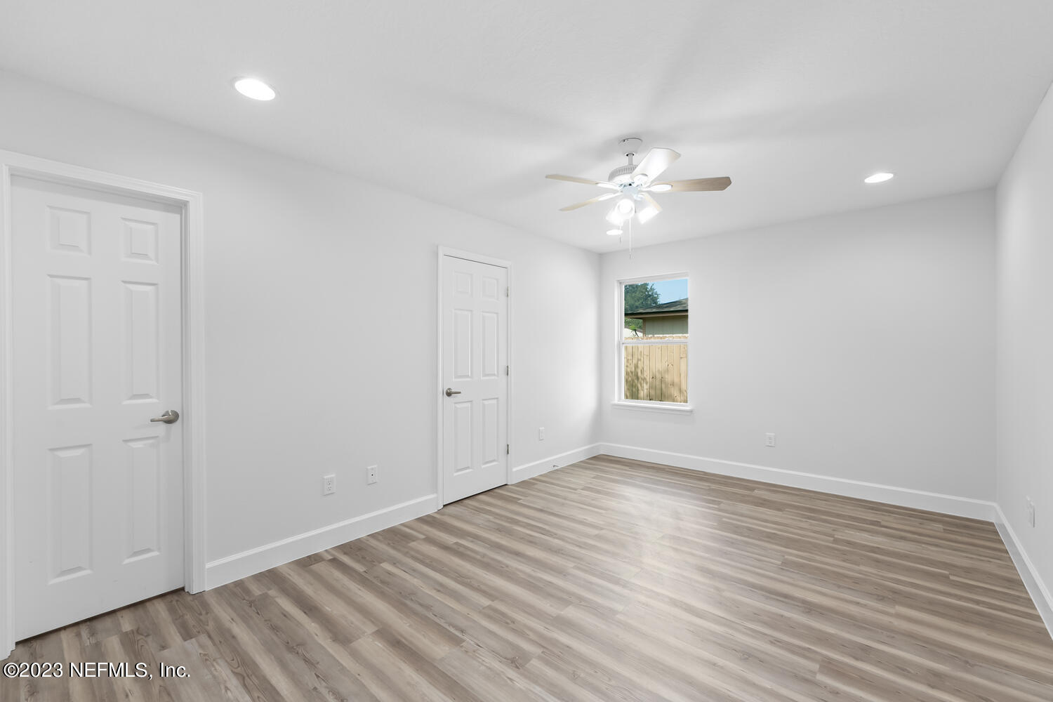 3748 Foxcroft Road Jacksonville, FL 32257 - Photo 19 of 33 wooden floor in an empty room with a window