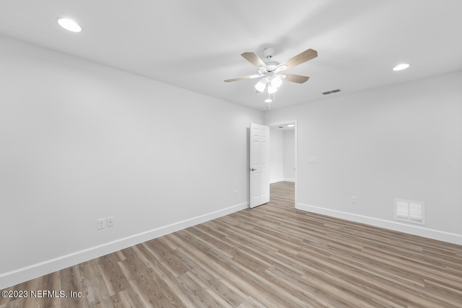 3748 Foxcroft Road Jacksonville, FL 32257 - Photo 20 of 33 wooden floor in an empty room with a window