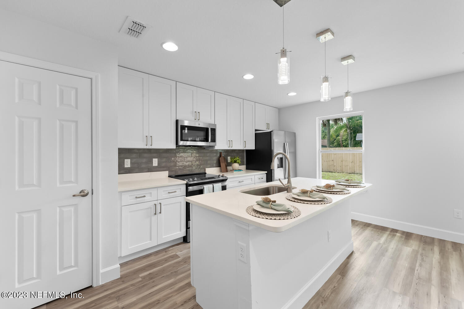 3748 Foxcroft Road Jacksonville, FL 32257 - Photo 2 of 33 a kitchen with a stove a sink a refrigerator and a microwave