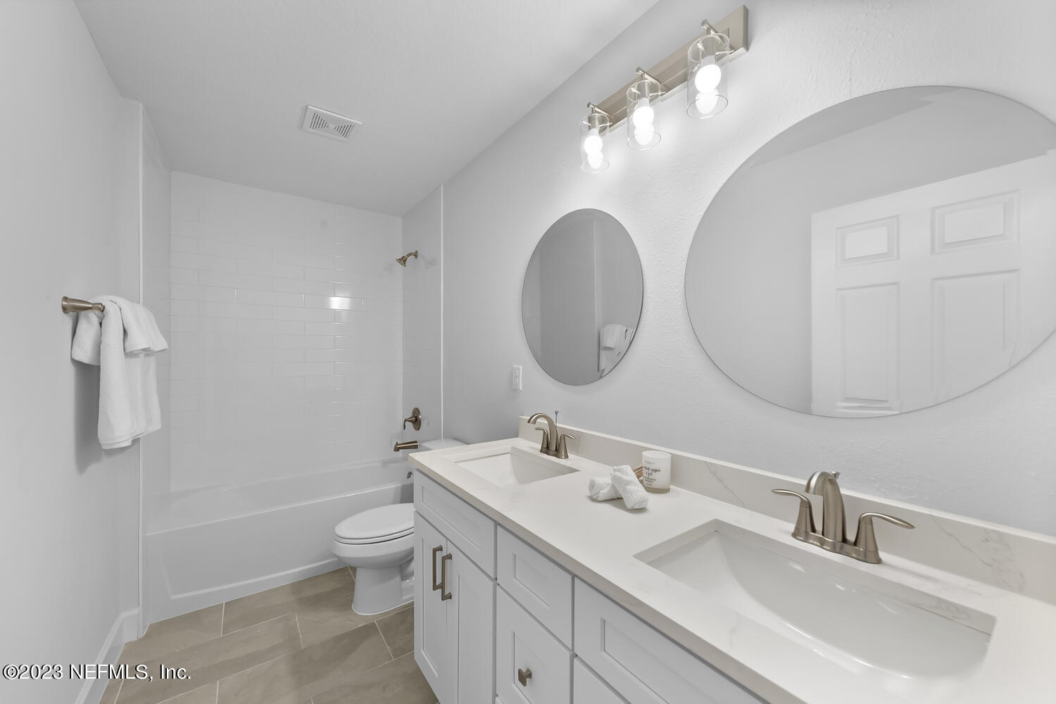 3748 Foxcroft Road Jacksonville, FL 32257 - Photo 24 of 33 a bathroom with a toilet a double vanity sink and a mirror