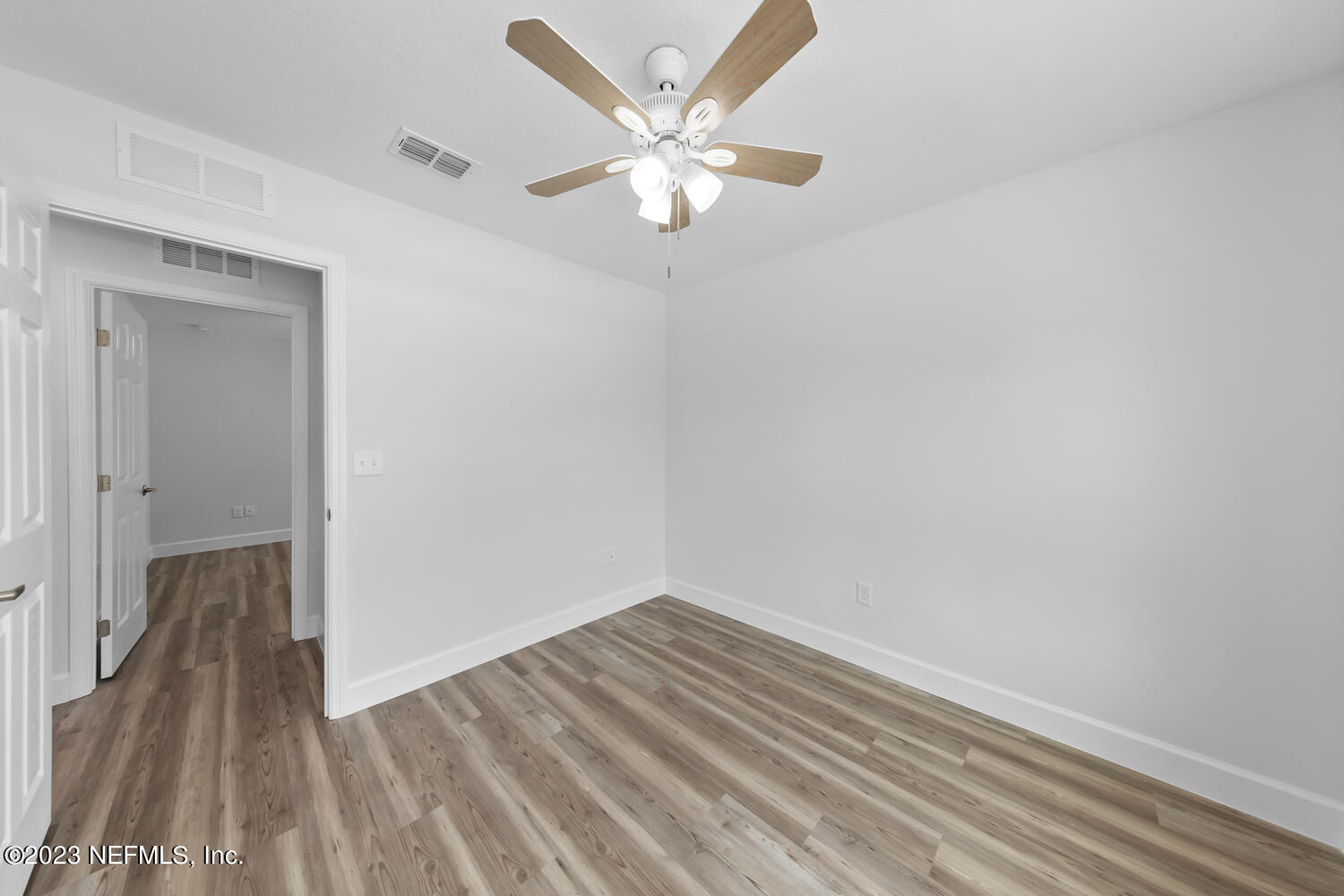 3748 Foxcroft Road Jacksonville, FL 32257 - Photo 29 of 33 a view of a room with wooden floor and a ceiling fan