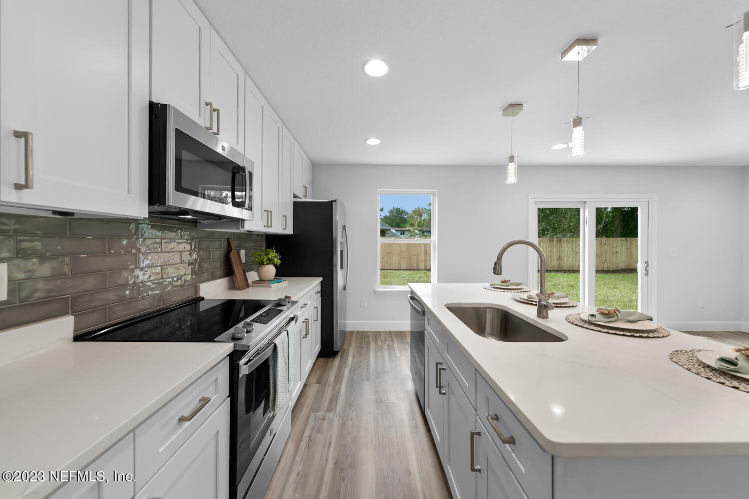 3748 Foxcroft Road Jacksonville, FL 32257 - Photo 3 of 33 a kitchen that has a sink and a stove