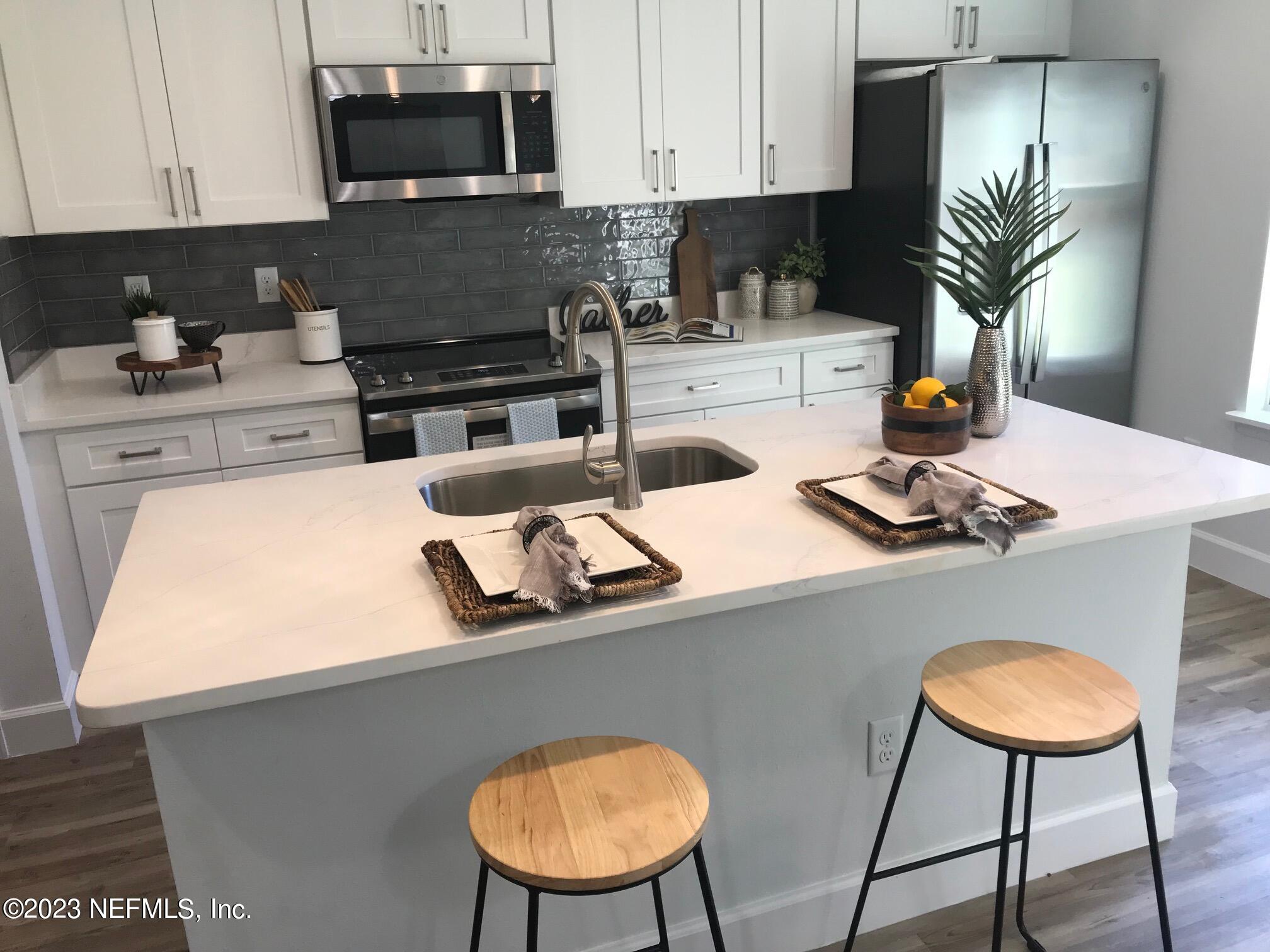 3748 Foxcroft Road Jacksonville, FL 32257 - Photo 4 of 33 a kitchen with appliances a sink and a stove