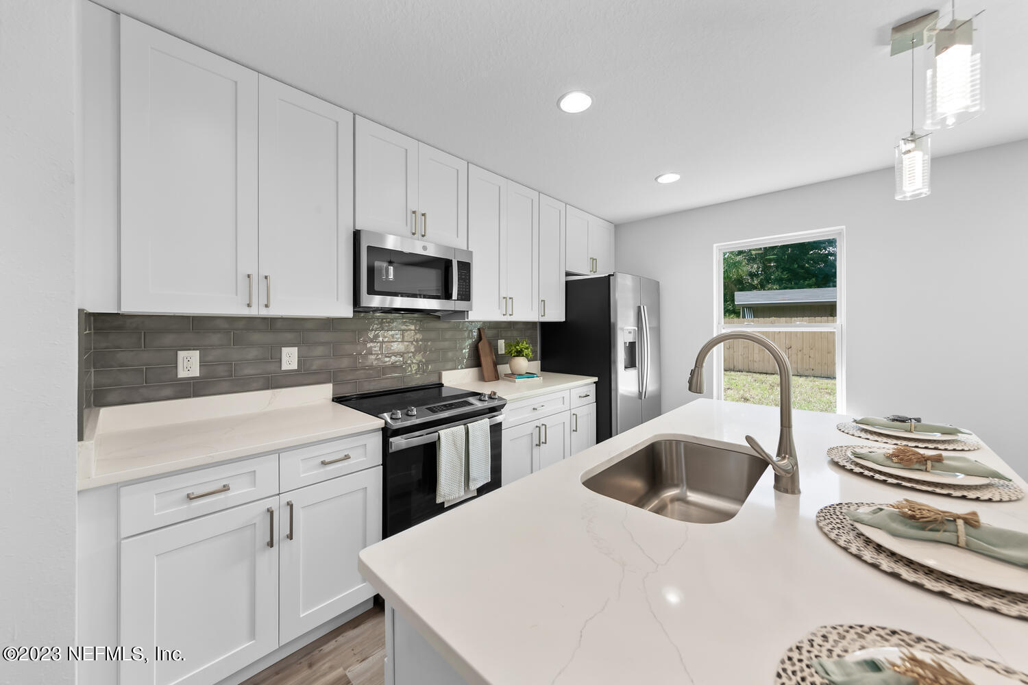 3748 Foxcroft Road Jacksonville, FL 32257 - Photo 5 of 33 a kitchen with white cabinets sink and stainless steel appliances