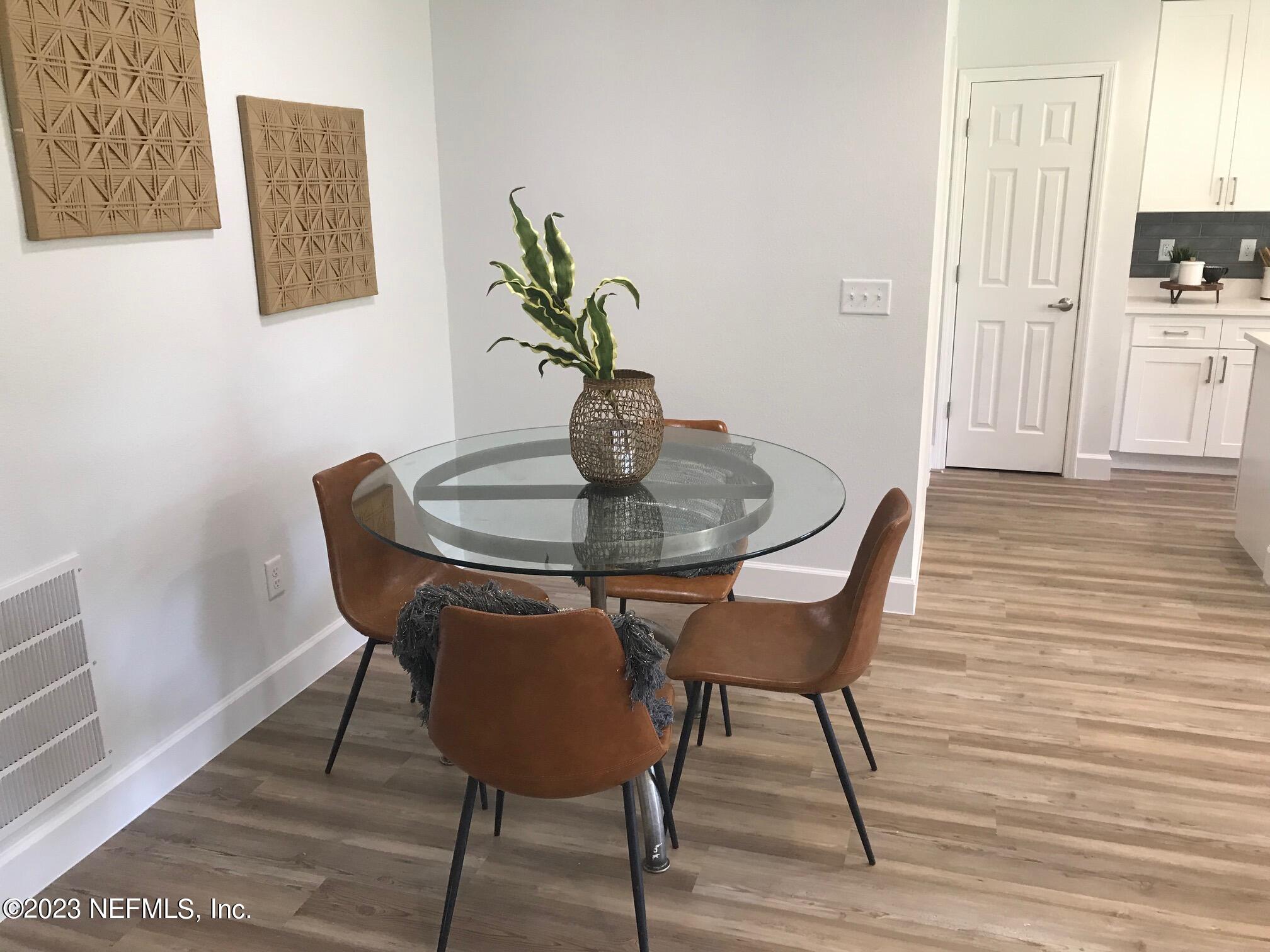 3748 Foxcroft Road Jacksonville, FL 32257 - Photo 8 of 33 a dining room with furniture and wooden floor