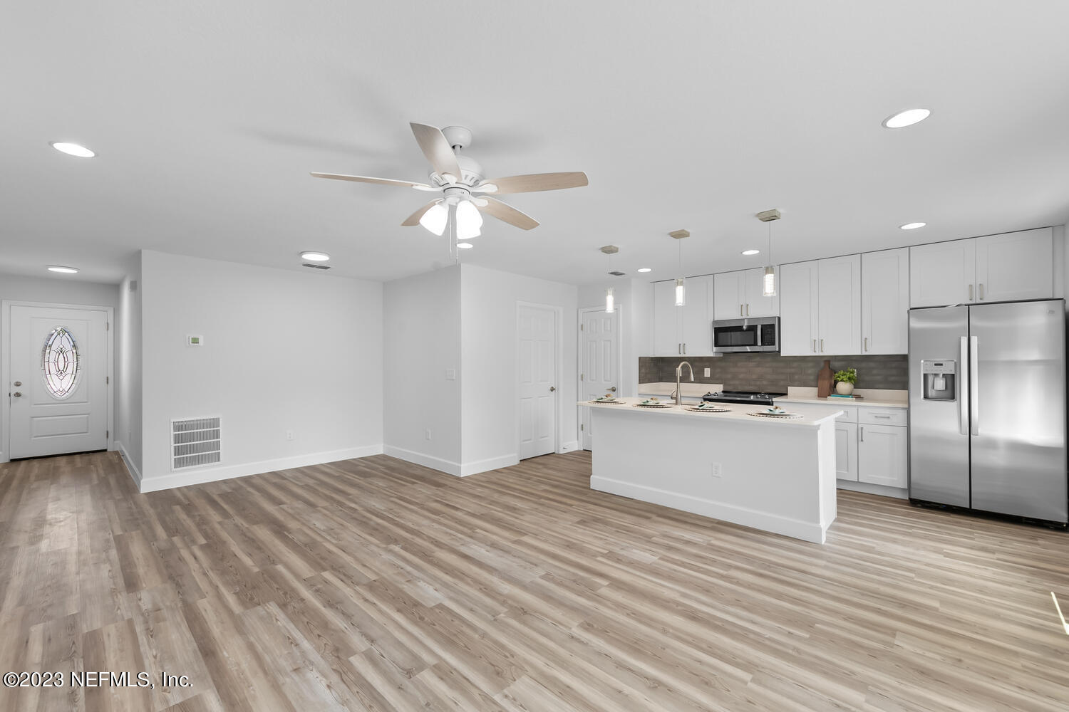 3748 Foxcroft Road Jacksonville, FL 32257 - Photo 9 of 33 a large white kitchen with kitchen island a sink stainless steel appliances and cabinets