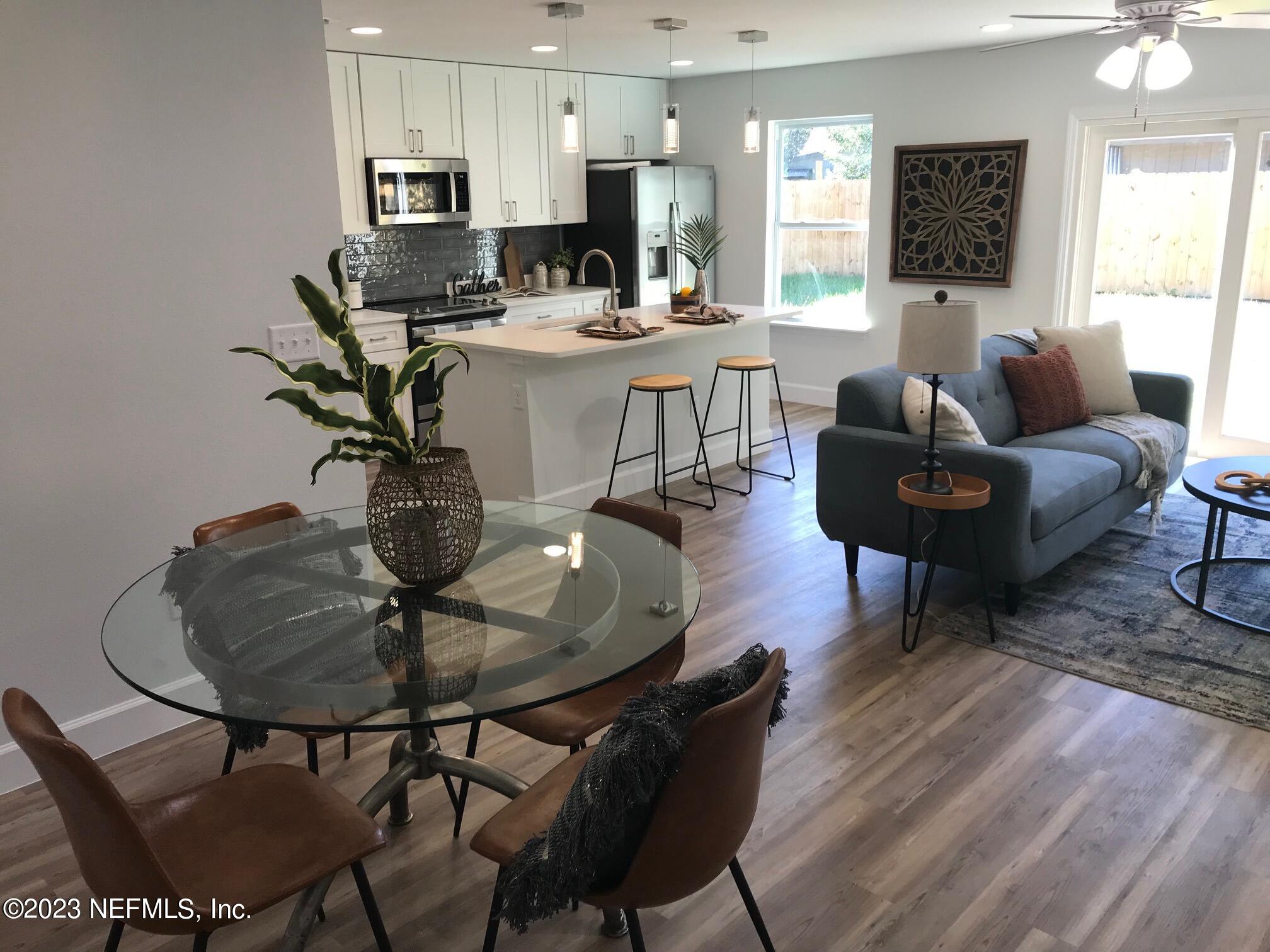 3748 Foxcroft Road Jacksonville, FL 32257 - Photo 10 of 33 a living room with furniture a dining table and a potted plant