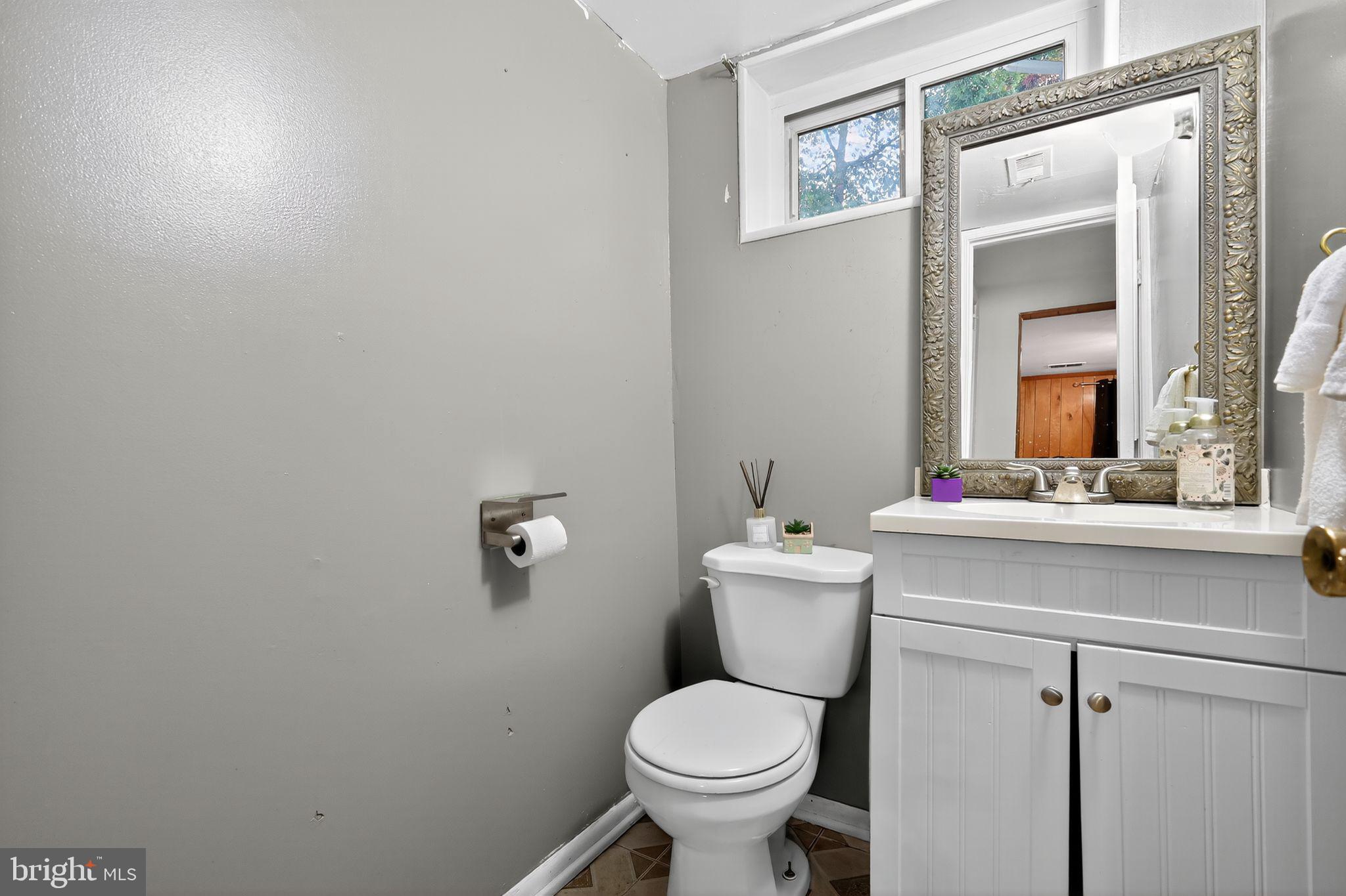 2924 Gracefield Road Silver Spring, MD 20904 - Photo 17 of 29 a bathroom with a toilet sink and mirror
