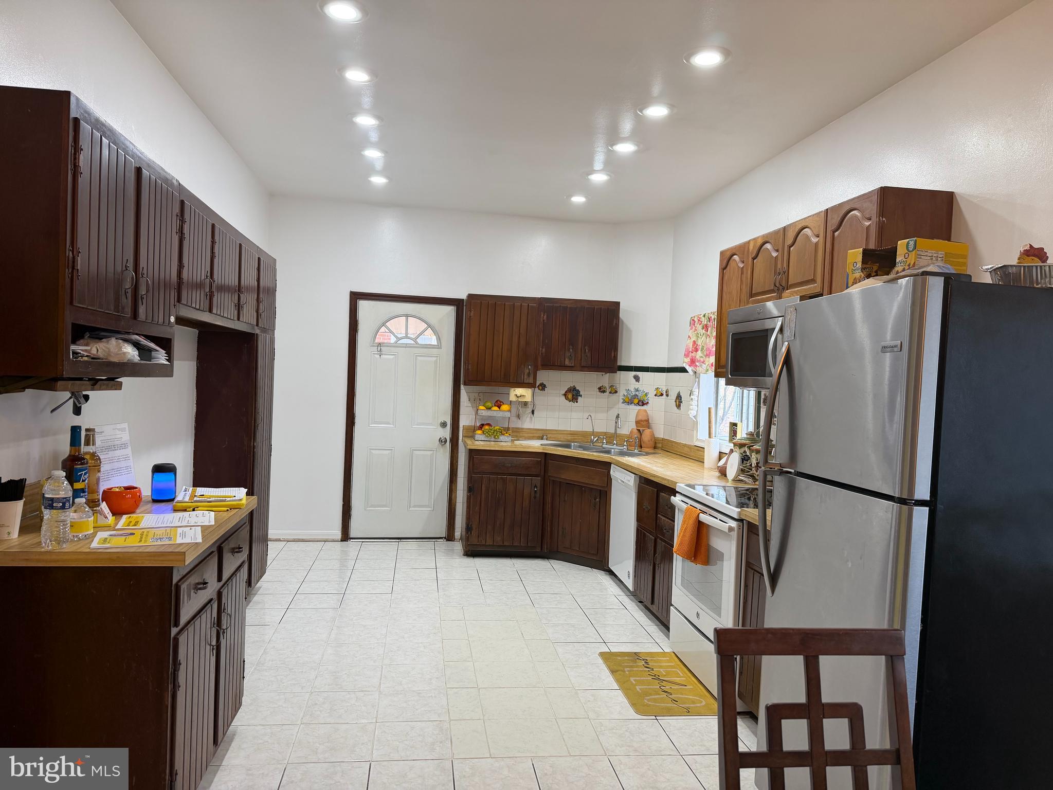 2924 Gracefield Road Silver Spring, MD 20904 - Photo 6 of 29 a kitchen with stainless steel appliances a refrigerator sink and cabinets