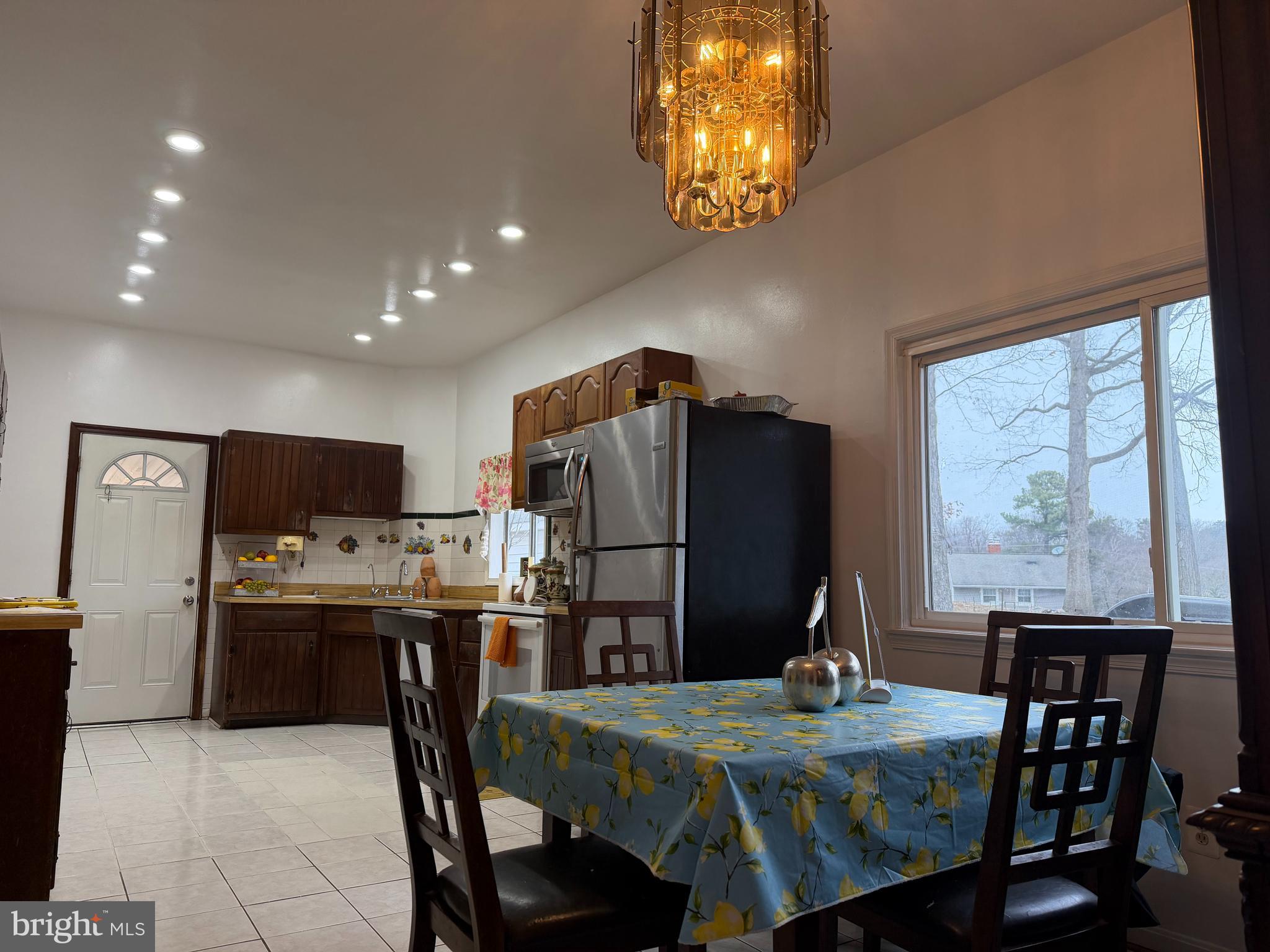 2924 Gracefield Road Silver Spring, MD 20904 - Photo 7 of 29 a kitchen with kitchen island a dining table and chairs