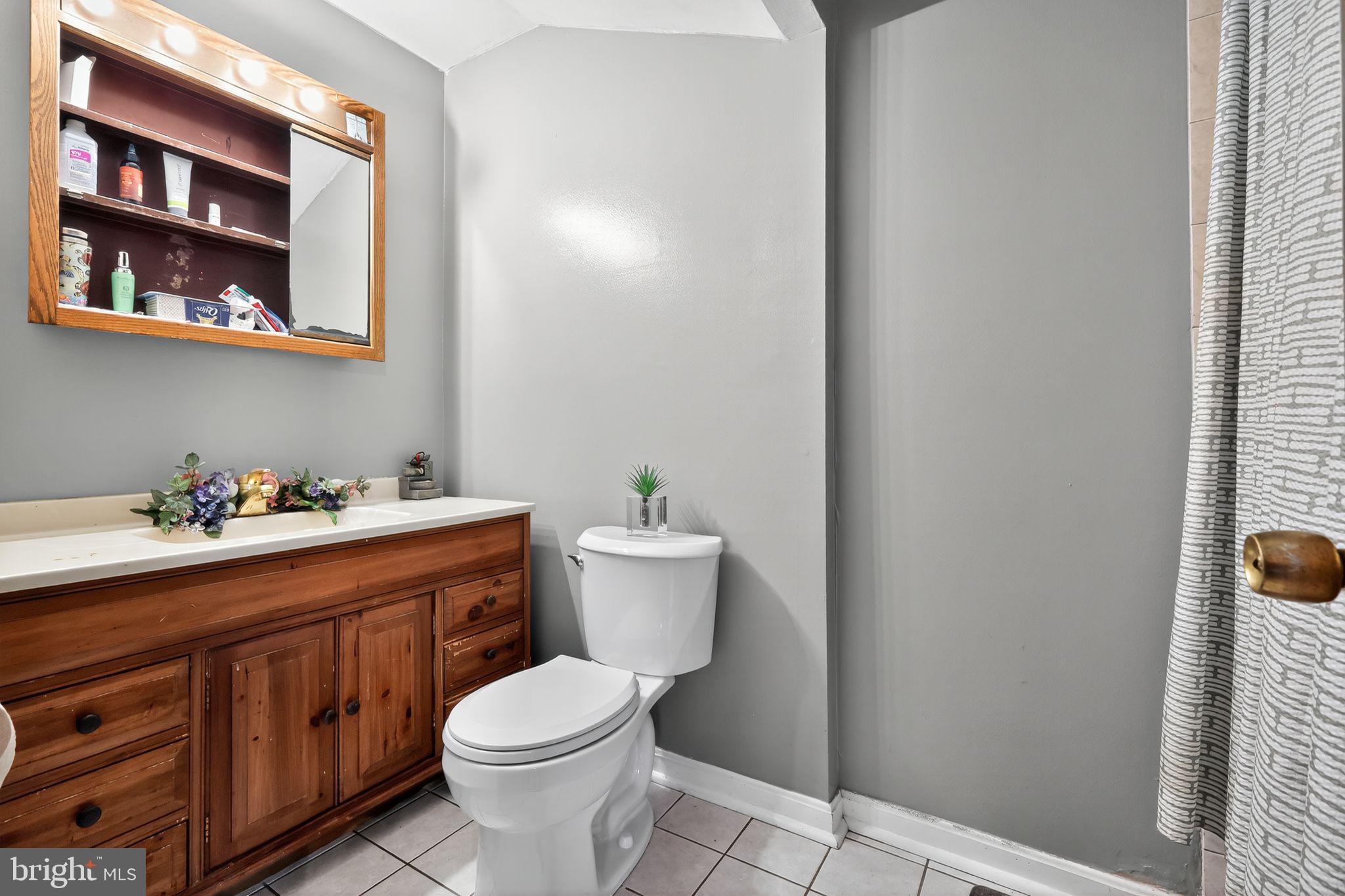 2924 Gracefield Road Silver Spring, MD 20904 - Photo 10 of 29 a bathroom with a toilet sink and mirror