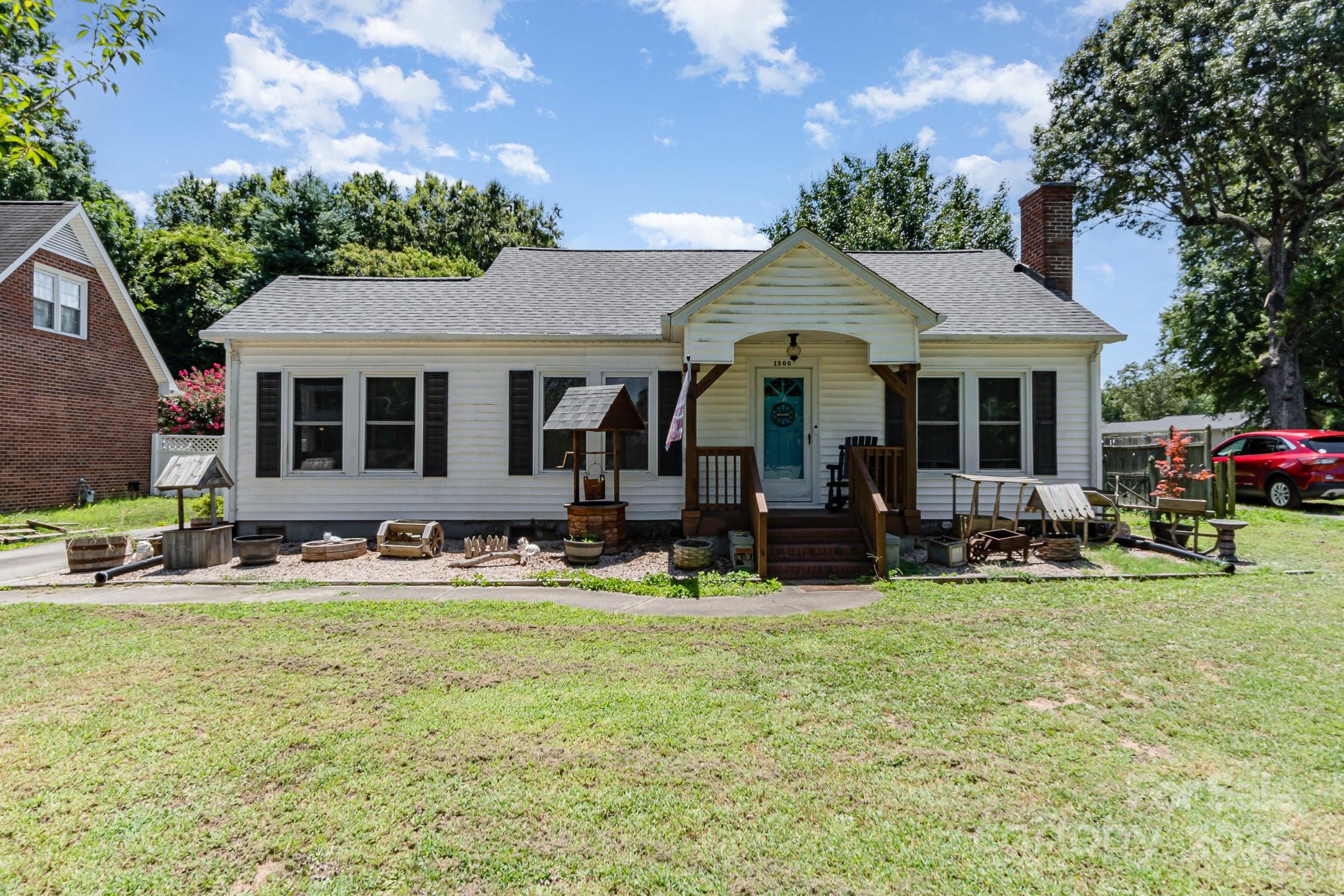 a view of a house with backyard porch and sitting area