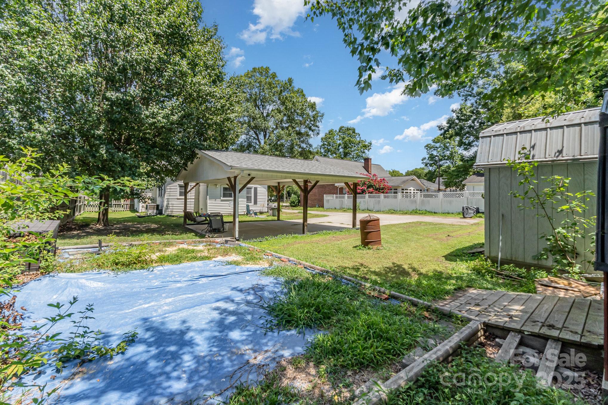 1306 Brantley Road Kannapolis, NC 28083 - Photo 28 of 29 a view of pool with lawn chairs and large trees