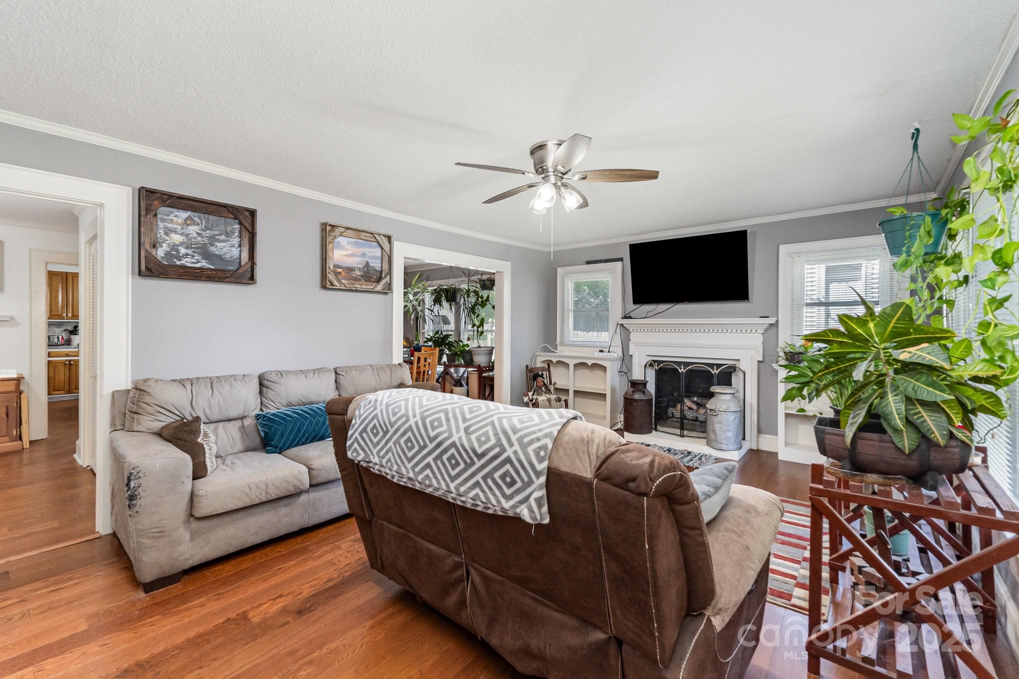 1306 Brantley Road Kannapolis, NC 28083 - Photo 4 of 29 a living room with furniture a fireplace and a flat screen tv