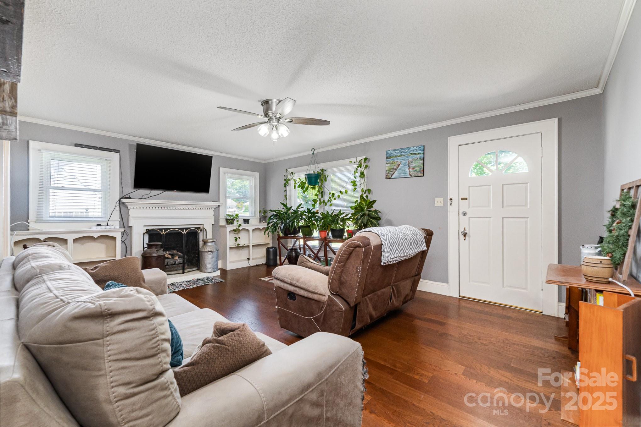 1306 Brantley Road Kannapolis, NC 28083 - Photo 5 of 29 a living room with furniture a fireplace and a flat screen tv