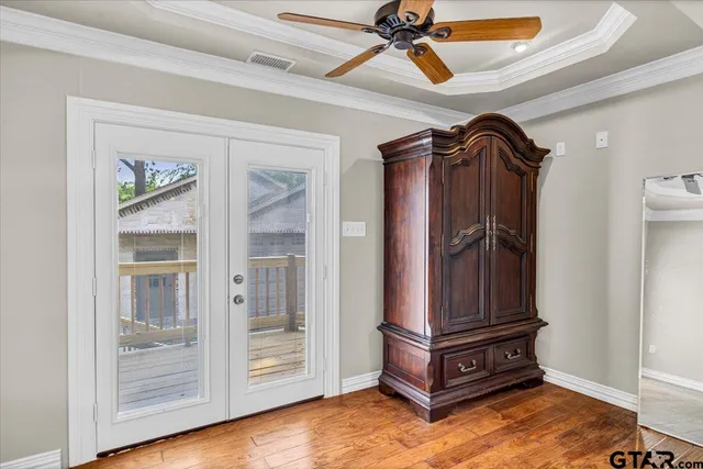 a room with gym equipment and wooden floor