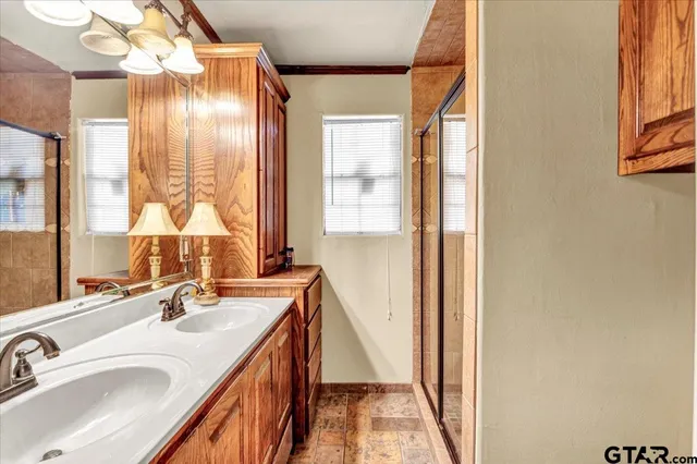 a bathroom with a granite countertop sink and a large mirror