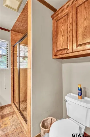 a white toilet sitting next to a bathroom and a sink
