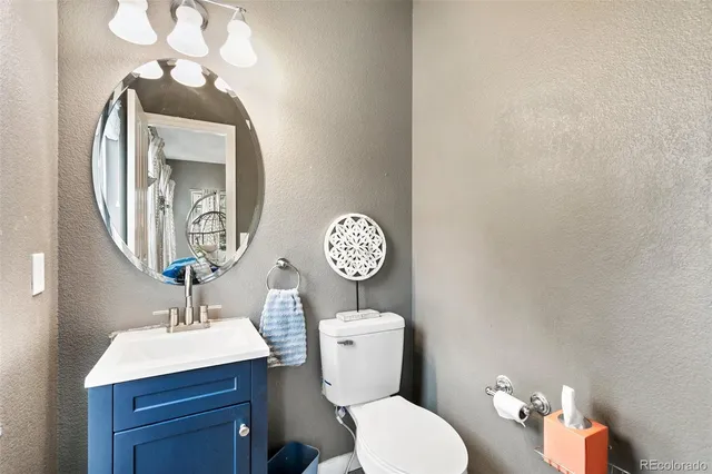 a kitchen with granite countertop a sink cabinets stainless steel appliances and a window