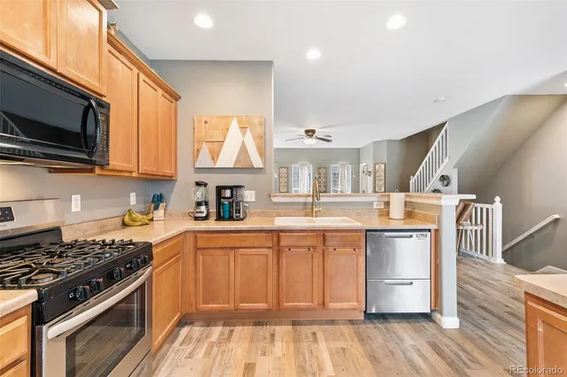 a kitchen with stainless steel appliances a stove microwave and refrigerator