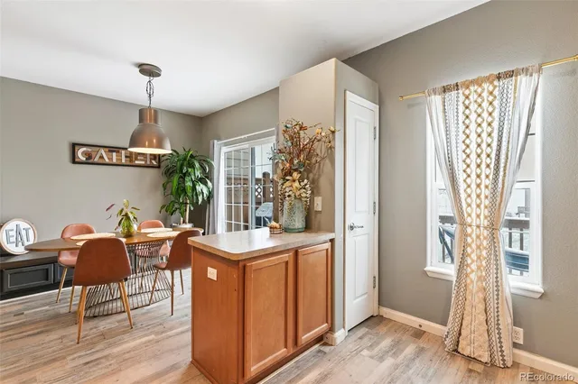 a dining room with furniture a chandelier and wooden floor