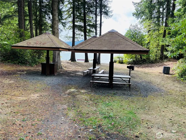 a view of a house with a yard and sitting area