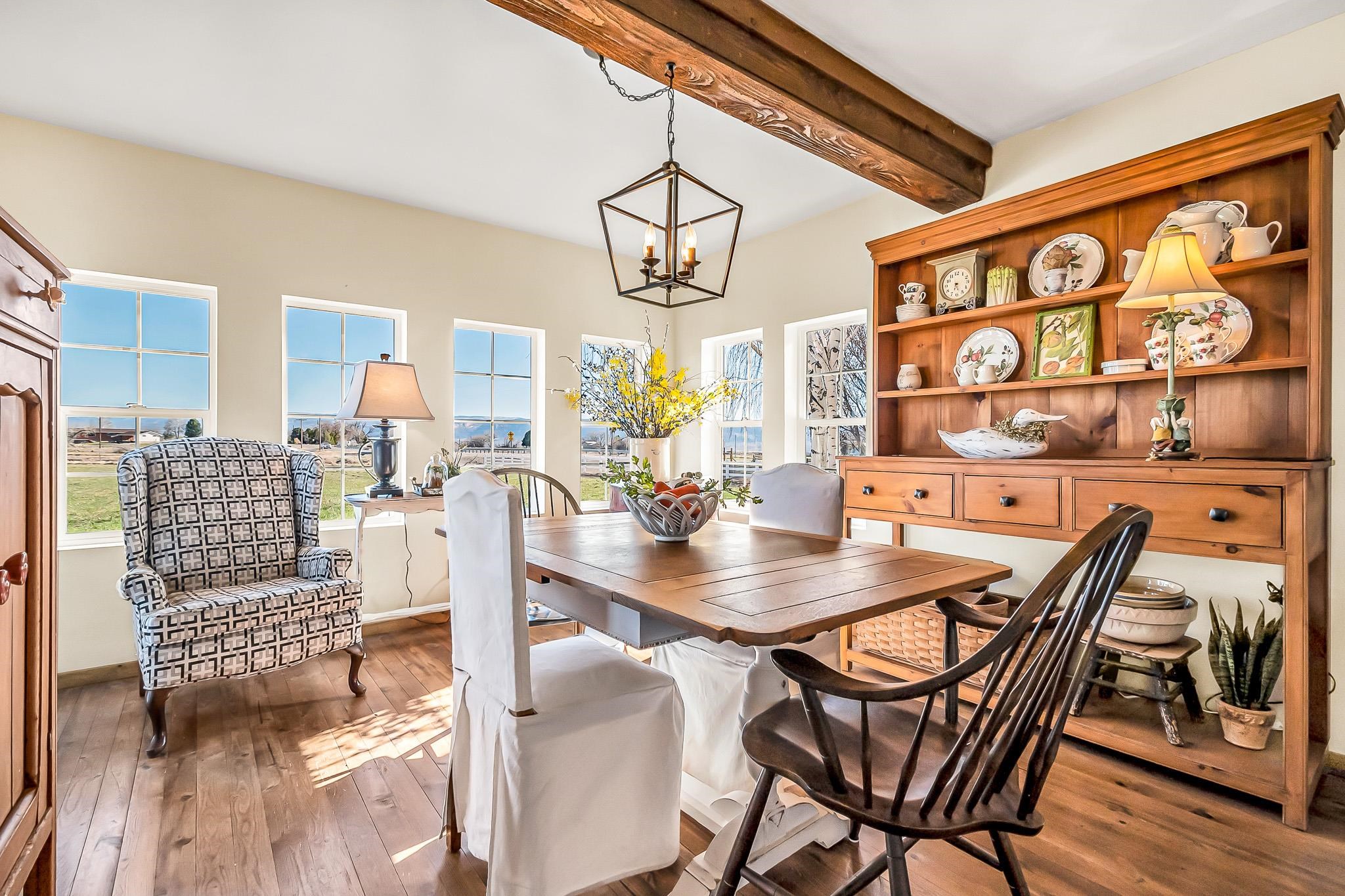 912 24 Road Grand Junction, CO 81505 - Photo 14 of 42 a view of a dining room and livingroom with furniture wooden floor and a rug