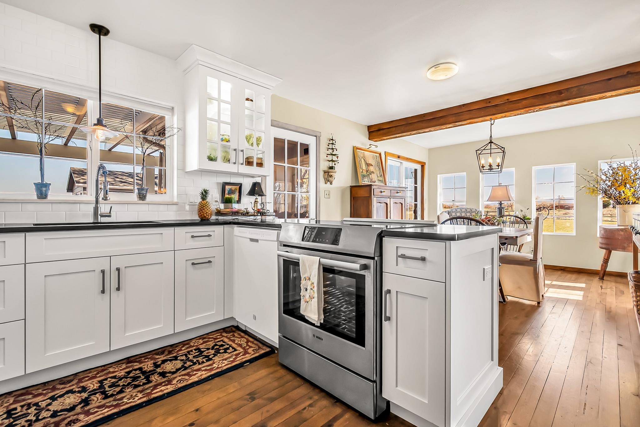 912 24 Road Grand Junction, CO 81505 - Photo 16 of 42 a kitchen with stainless steel appliances granite countertop a stove a sink and a refrigerator