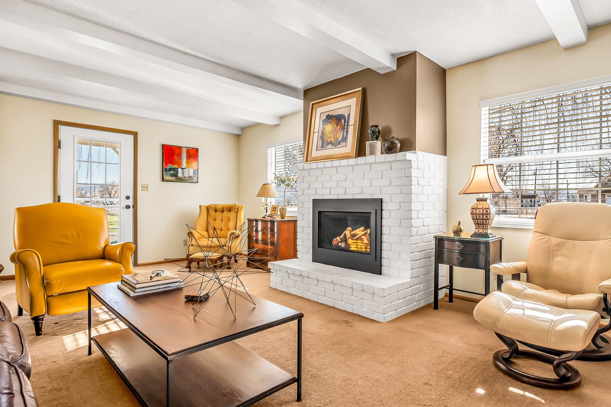 912 24 Road Grand Junction, CO 81505 - Photo 6 of 42 a living room with furniture and a fireplace