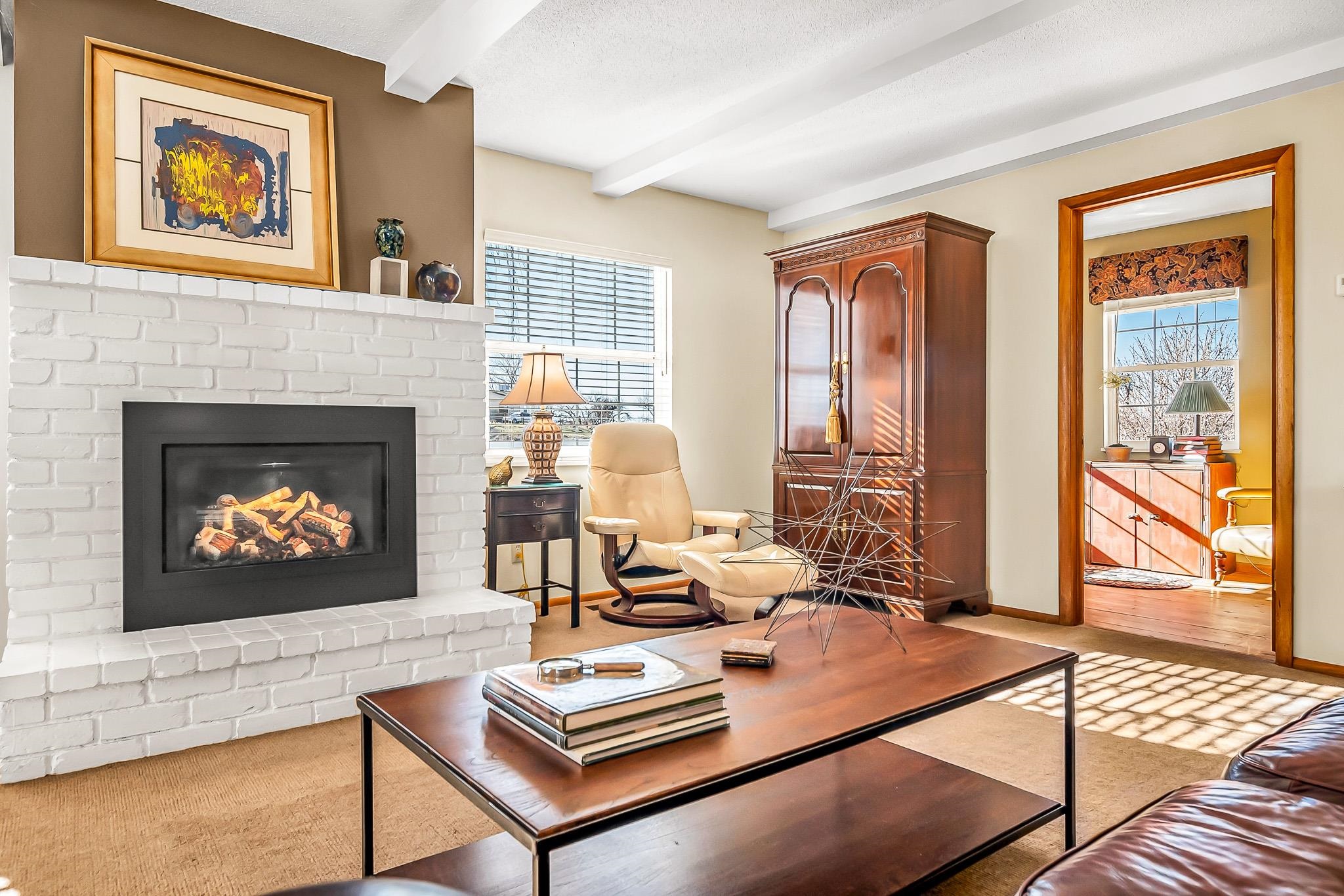 912 24 Road Grand Junction, CO 81505 - Photo 7 of 42 a living room with furniture a fireplace and a floor to ceiling window
