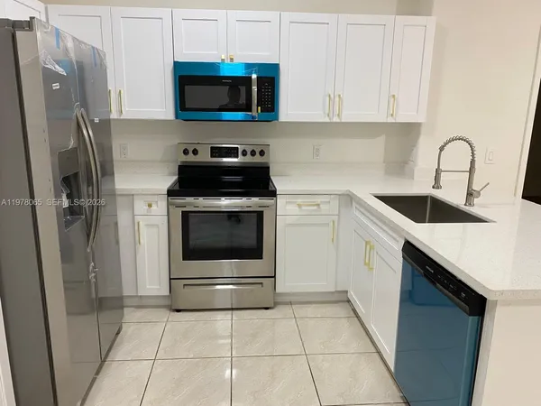 a kitchen with a sink a stove and refrigerator
