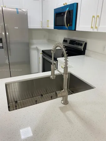 a view of a kitchen with a sink and an oven
